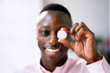Man Holding Continuous Glucose Monitor
