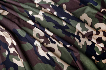 close up of the camouflage textured fabric wavy background