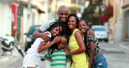 Beautiful black family embrace. Loving father hugging wife and children. African ethnicity