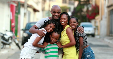 Beautiful black family embrace. Loving father hugging wife and children. African ethnicity