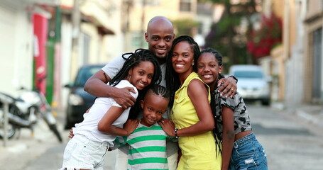 Beautiful black family embrace. Loving father hugging wife and children. African ethnicity