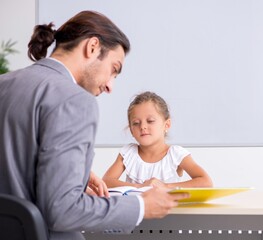Teacher with young girl in the classroom