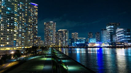 Night view of a high-rise condominium along an urban river_36