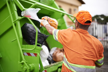 One mans trash.... Cropped shot of a garbage collection worker.