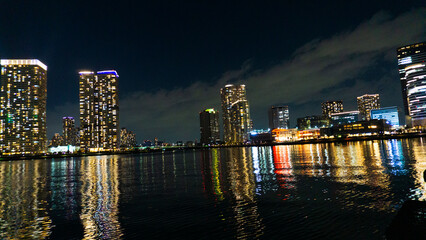 Night view of a high-rise condominium along an urban river_41