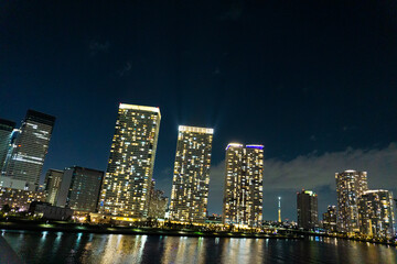 Fototapeta na wymiar Night view of a high-rise condominium along an urban river_49