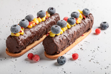 Sweet and tasty chocolate bar with berries on biscuits