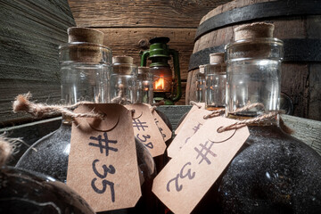 Good cognac in distillery with labeled bottles.