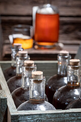 Golden whisky with ice in a glass in the cellar.