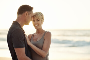 Fototapeta na wymiar The sun shines on their love. Shot of a mature couple enjoying a day at the beach.