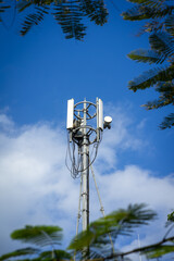 Telephone antenna on blue sky background.