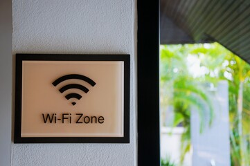 Wireless internet sign on the wall near with sun bed on the grass field, relaxing and working...