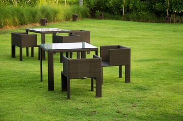 Terrace, Cushion made of fabric and furniture oautdoor table set. Placed on an artificial green grass, table set for dining decorating with artificial grass circle shape on the floor.