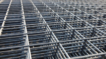 Steel wire mesh pile. BRC welded wire mesh for slab construction in natural light top view....