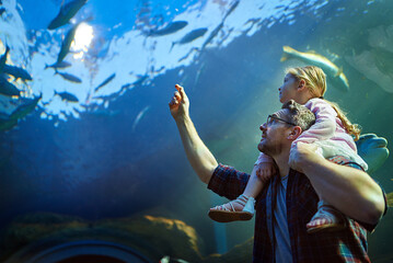 Getting up close with all the sea creatures. Cropped shot of a father and his little daughter...