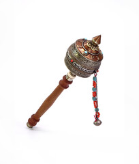 Tibetan hand prayer wheel isolated on white background. A prayer wheel is a cylindrical wheel on a...