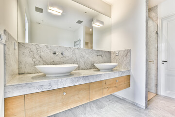 Double sink in modern stylish bathroom with walk-in shower