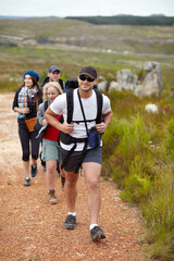 Fototapeta premium They enjoy hitting at trail. A happy group of friends walking the hiking trails together.