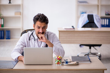 Young male doctor working in the clinic