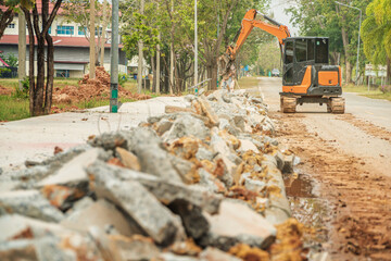 Fototapeta premium Drilling and demolishing the concrete pavement of the roadside pavement. Drilling into the pavement with a big truck is a very good machine.