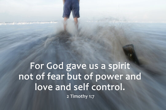 Bible verse inspirational quote - For God gave us a spirit not of fear but of power and love and self control. 2 Timothy 1:7 With person standing alone on strong wave motion in long exposure on beach.