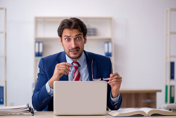 Young male employee working in the office