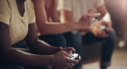 Im going to kick your butt at this game. Shot of a group of friends playing console games at home. © Kobus L/peopleimages.com