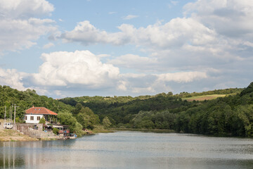 Obraz premium Remote house, isolated, standing in a quiet environment on a lake, on Duboki Potok jezero lake, by Barajevo, in the southern rural part of Belgrade, Serbia. ..