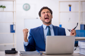 Young businessman employee and too much work in the office