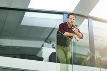 Keep pace with your on-the-go clients. Shot of a businessman using his cellphone in a modern office.