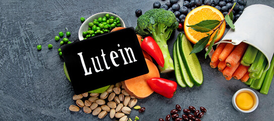 Foods high in lutein on dark background.