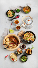 Assorted Chinese food set on light background.