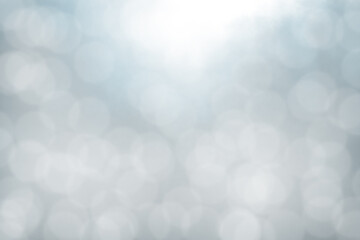 Towards to light through the opening above with diffused points of light shimmering on a light gray - blue background below