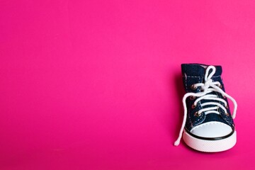 lonely shoes on pink background