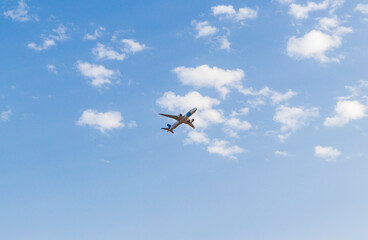Fototapeta na wymiar Shot of an airplane on blue sky background. Aviation