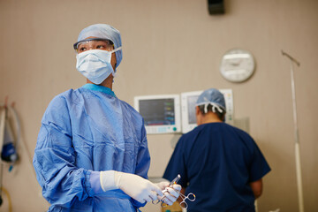 Shes got life saving experience. Shot of a surgeon ready to perform a surgery in an operating room. - Powered by Adobe
