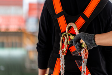 Construction worker wearing safety harness and safety line