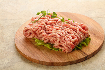 Raw minced pork meat over board