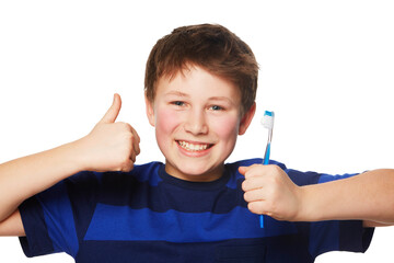 Dental hygiene gets the thumbs up. Portrait of a young boy holding is toothbrush and giving a thumbs up.
