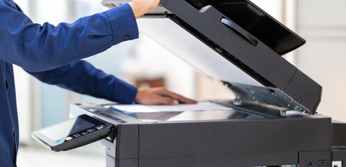 Businessman press button on panel of printer photocopier  network , Working on photocopies in the...