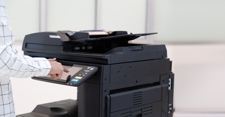 Bussinessman press button on panel of printer photocopier  network , Working on photocopies in the office concept , printer is office worker tool equipment for scanning and copy paper.