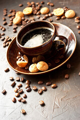 Obraz na płótnie Canvas Cup of coffee and tasty cookies on dark background