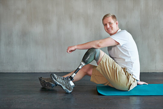 When The Mind Is Strong, The Body Follows. Shot Of A Young Amputee Working Out On A Gym Floor.