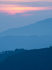 Beautiful nature of sunrise and mountains complex with morning mist atmosphere at Tak, Thailand.