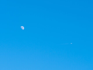 White Jet Plane Flies Away from The Moon