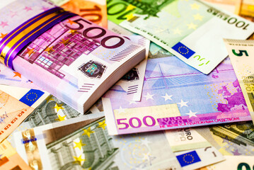 A pack of European currency lies on the background of the Euro - obrazy, fototapety, plakaty