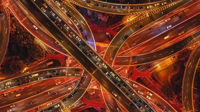 Aerial footage of busy traffic on viaduct in Shanghai at night, China. High angle shot of traffic in China.