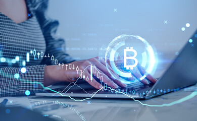 Businesswoman working with computer, bitcoin hologram, binary with candlesticks