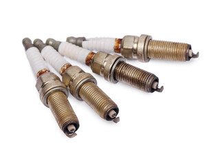 Four old used spark plugs