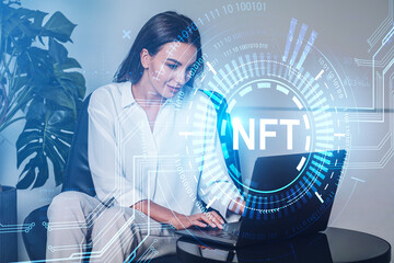 Young attractive businesswoman wearing formal wear is typing on laptop